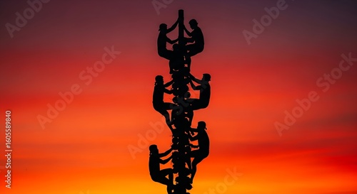 United Ascent Human Tower Silhouette Against a Fiery Sunset Sky.
