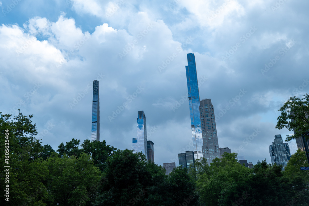 Obraz premium Urban Giants Over Green Spaces