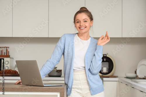 Young woman using modern la...