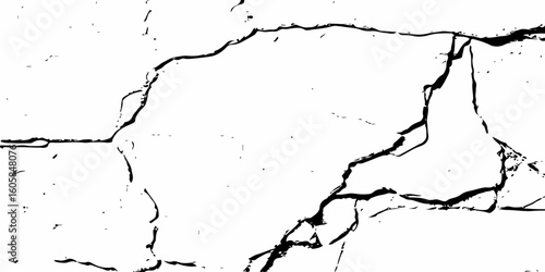 white surface with a network of black cracks across the surface area.