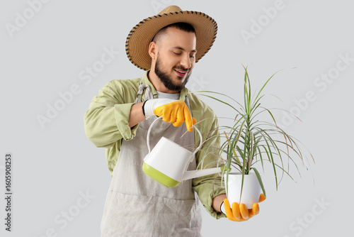 Male gardener watering plan...