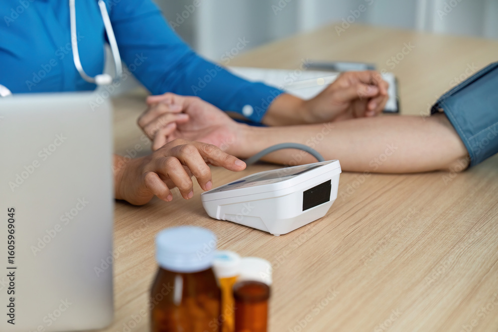 Fototapeta premium Doctor monitoring patient health with medical equipment in a clinical environment