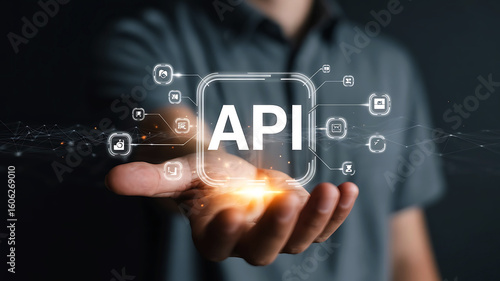 Man holding a glowing transparent phone displaying the word api surrounded by digital icons and network connections