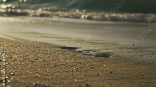 Wallpaper Mural Golden Sandy Beach Footprints and Gentle Waves Wash Marks Away in Serene Coastal Scenery Low Angle Torontodigital.ca