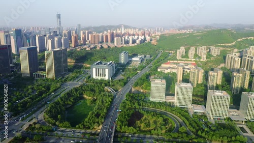 Driving through a busy urban highway tunnel in a modern city surrounded by high-rise buildings and green spaces