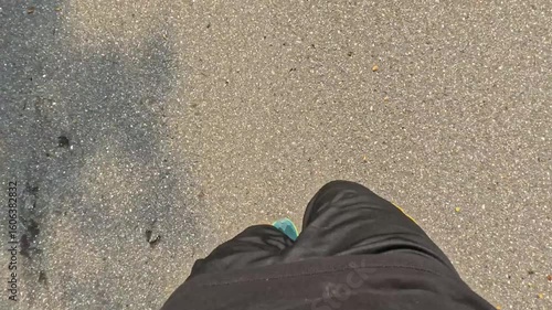 point of view of man foot running on asphalt road with shadow in the morning