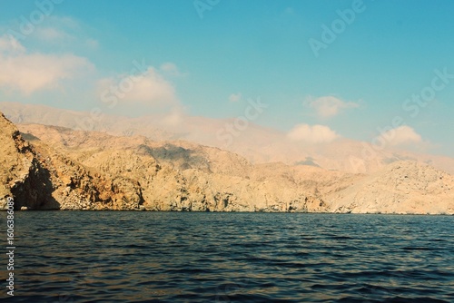 Sunset over the sea and rugged Omani Coast Line 