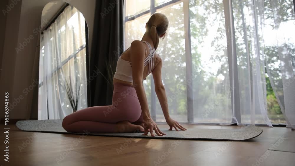 Woman practicing graceful yoga poses in a tranquil setting with effortless flow Woman practicing graceful yoga poses in a tranquil setting with effortless flow
