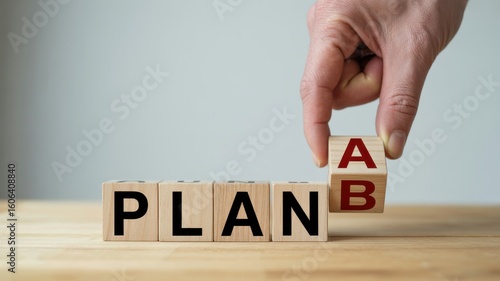 Business strategy and planning concept with a hand changing letter B to A on wooden blocks