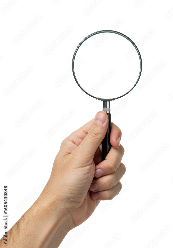 A light-skinned adult hand with clean nails firmly holds a classic magnifying glass with a clear lens, black handle, and silver frame, presented against an isolated, shadowless white studio A light-skinned adult hand with clean nails firmly holds a classic magnifying glass with a clear lens, black handle, and silver frame, presented against an isolated, shadowless white studio