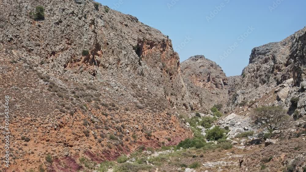 Rocky canyon with sparse vegetation on a sunny summer day in eastern Crete, Greece. Rocky canyon with sparse vegetation on a sunny summer day in eastern Crete, Greece.