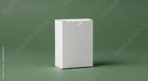 A real white vertical product box mockup for packaging on a solid green background.