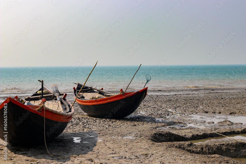 Fototapeta premium fishing boat on the beach at sunset in mousuni Island