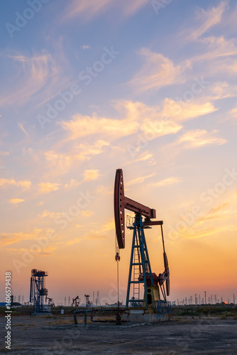 In the evening, oil pumps are running, Silhouette of beam pumping unit