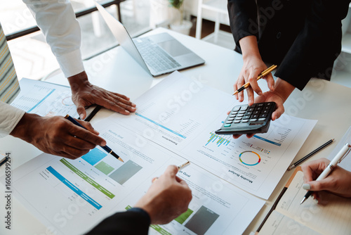 Young colleagues discussing business and price chart analyzes business people on the table great in modern coworking office teamwork concept. Calculate personal tax for customers