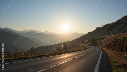 Winding road leading through mountainous landscape with trees and a bright sunlit sky at daytime