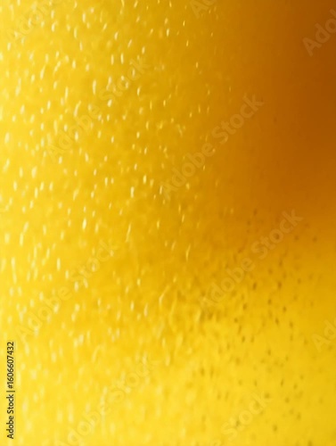 Golden lager beer being poured, creating a thick, frothy head as countless bubbles rise continuously and effervescently through the liquid. 