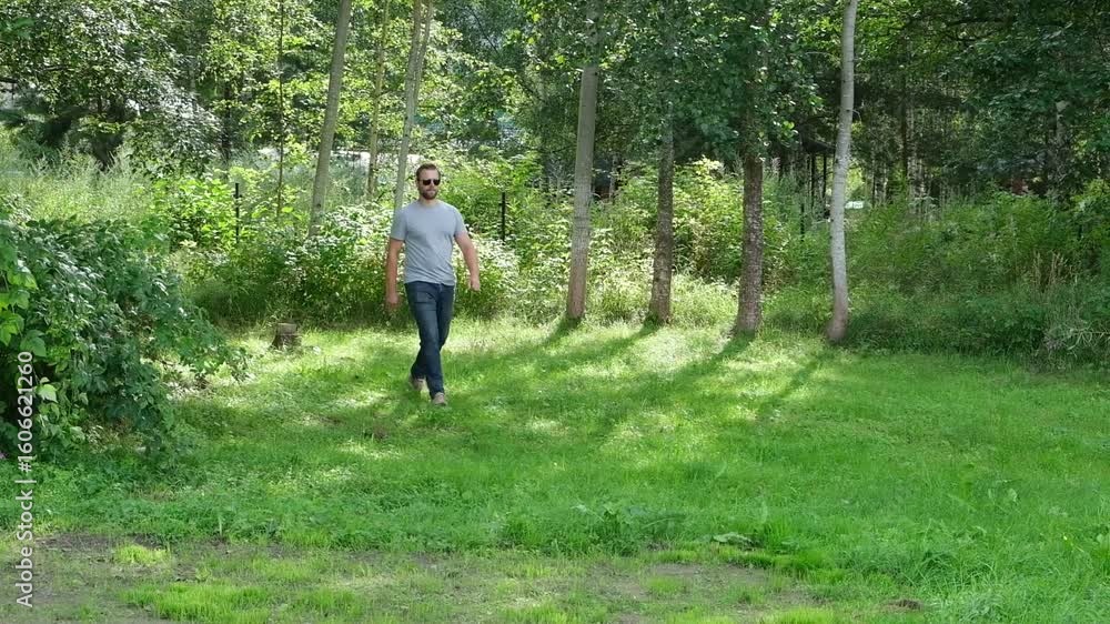 A person is hiking through a vibrant and colorful wildflower meadow in natures beauty. A man strolls through a vibrant wildflower meadow, surrounded by greenery and hills, enjoying nature A person is hiking through a vibrant and colorful wildflower meadow in natures beauty. A man strolls through a vibrant wildflower meadow, surrounded by greenery and hills, enjoying nature