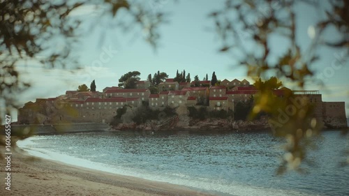 Explore the natural beauty and charm of Sveti Stefani beach on a sunny day in Montenegro