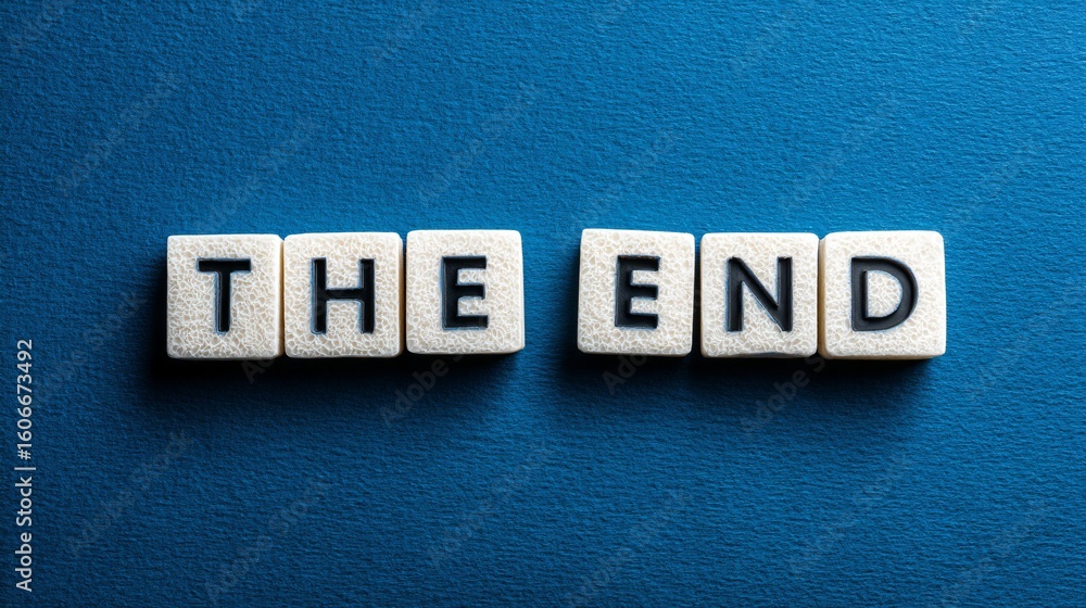 Obraz premium A conceptual photograph with a solid blue background, featuring white letter blocks arranged to spell out 