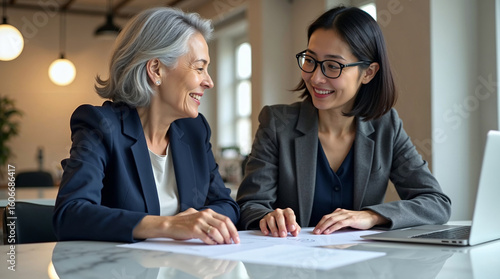 Professional Women Discussing Business Strategy in Contemporary Workspace