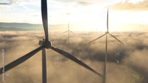 Aerial drone view of wind turbine above a misty community at sunrise. concept for green technology, community integration, and a hopeful future.