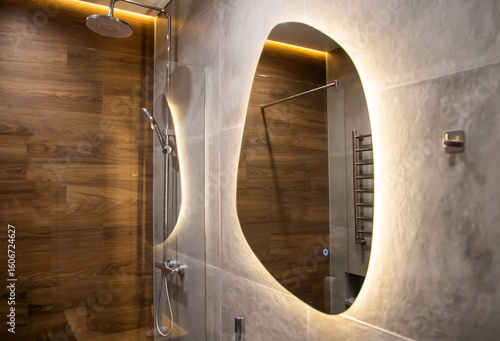 Wallpaper Mural Modern mirror with yellow LED backlight in the bathroom against the background of a chrome shower and brown wood tiles. Copy space for text Torontodigital.ca