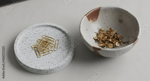 Golden Paperclips Rest on a Terrazzo Tray and Tacks Fill a Ceramic Bowl, Still Life