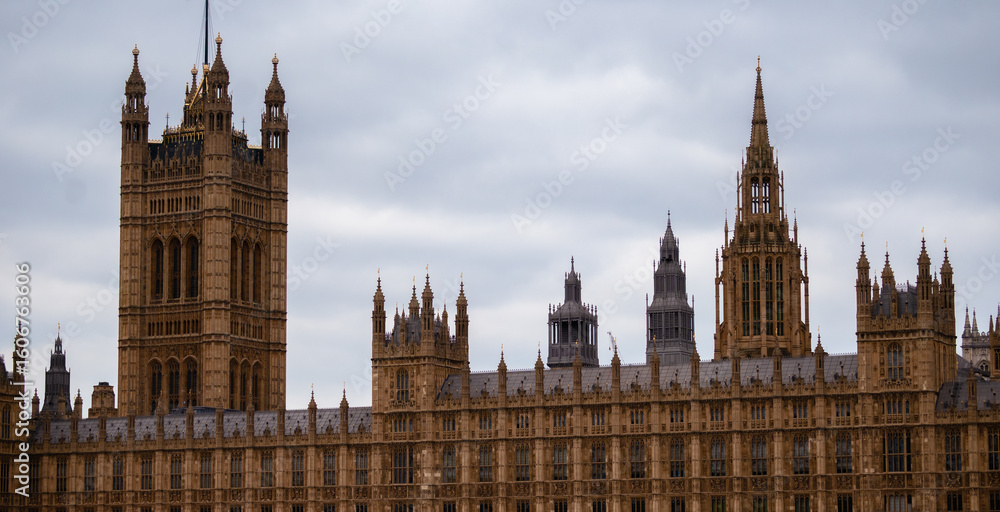 Obraz premium Palace of Westminster in central London on a cloudy day. Concept of government, politics, and historic British architecture near the iconic Big Ben clock tower