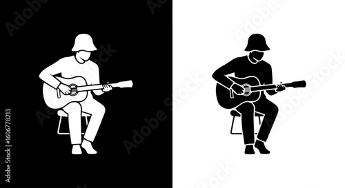 Silhouette of a person playing an acoustic guitar, black and white variations.