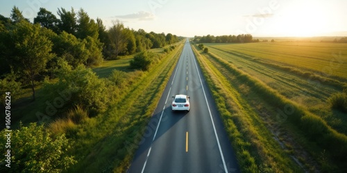 Car driving on an empty road during sunset in a rural landscape  