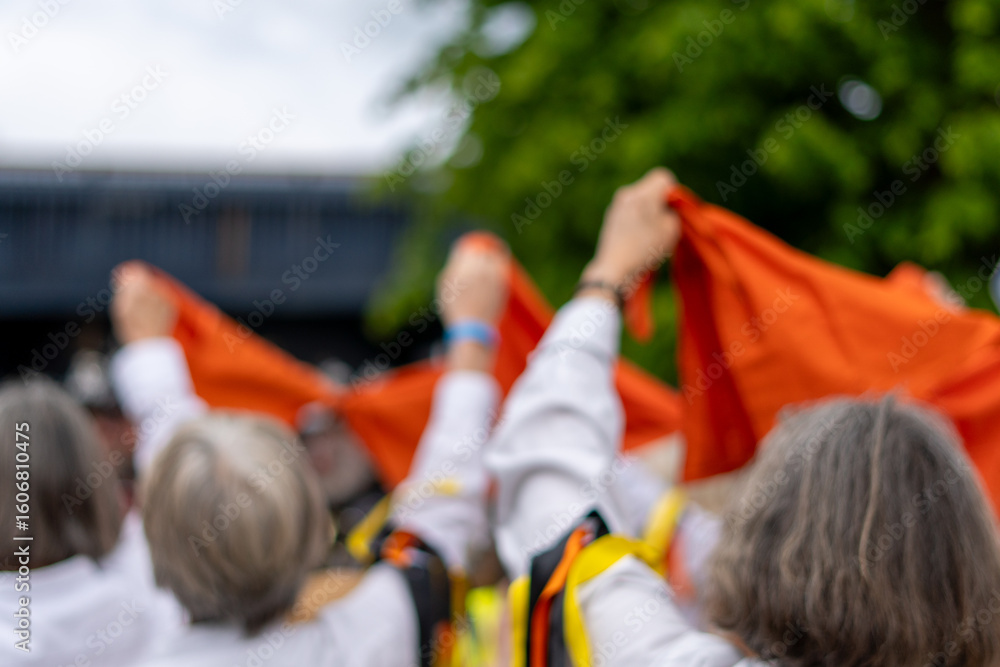 Obraz premium Morris dancers in the village street, Worcestershire, UK. Celebrating the May Day Bank Holiday, With a blurred edit