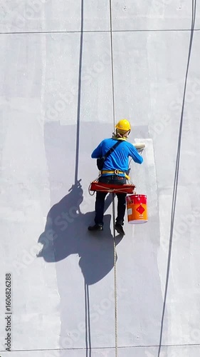 Painters Hanging from a Rope, Painting the Building Exterior Wall.	