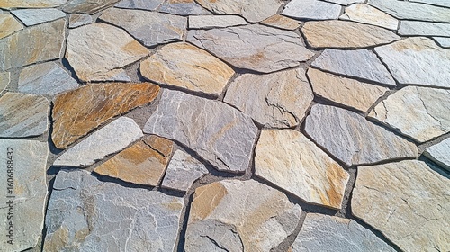 Flagstone texture natural stone pavers irregular pattern overhead shot weathered limestone surface beige gray color variations organic seamless background