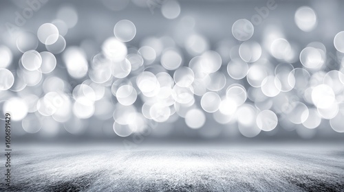 Soft, silvery bokeh lights against a gray background.