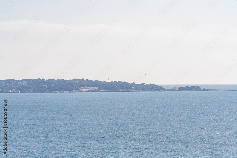 Peaceful panoramic seascape with distant coastline and clear blue horizon under soft sky – tranquil view for travel, wellness, or design backgrounds Peaceful panoramic seascape with distant coastline and clear blue horizon under soft sky – tranquil view for travel, wellness, or design backgrounds