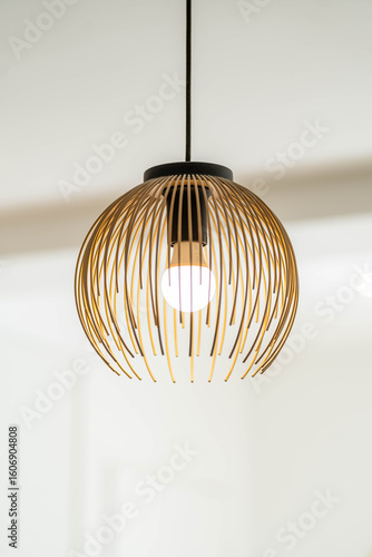 Obraz na plátně Modern wooden pendant light with spherical openwork design, minimalist ceiling l