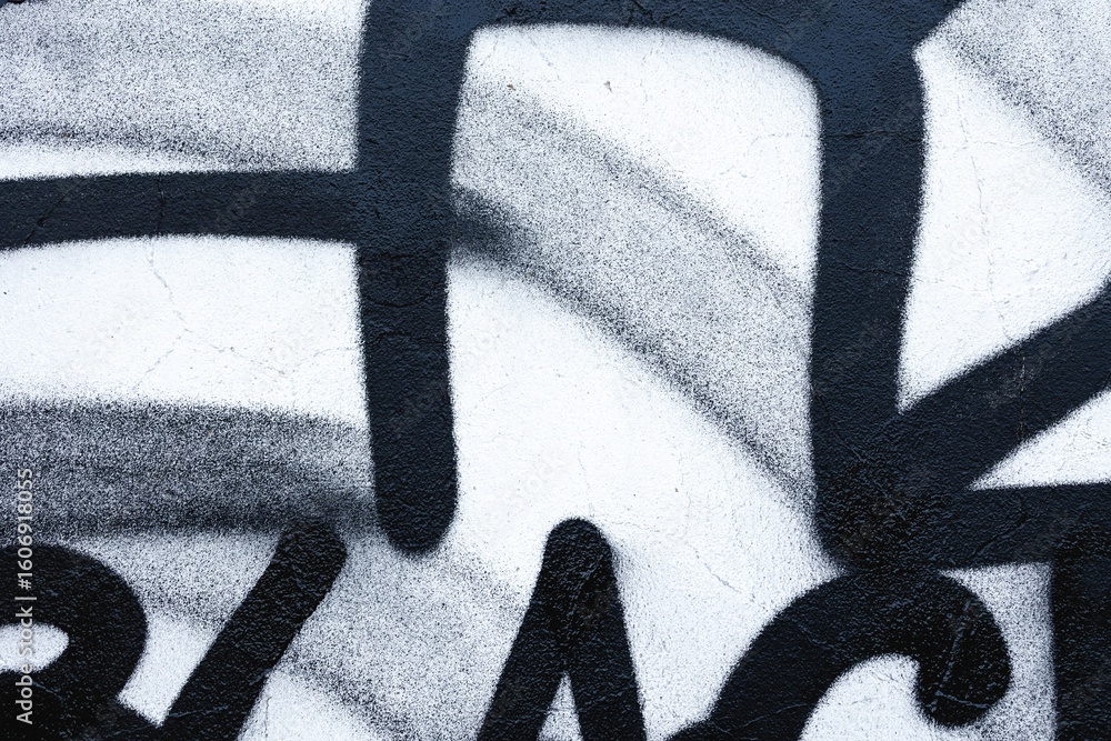 Naklejka premium Monochrome graffiti with bold black lines on textured wall. Urban, street art, retro 90s, abstract design. Posters, flyers, modern 2000s creative banner, digital art.
