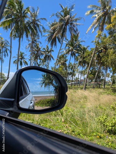 Summer beach reflection trough the side mirror during road trip 