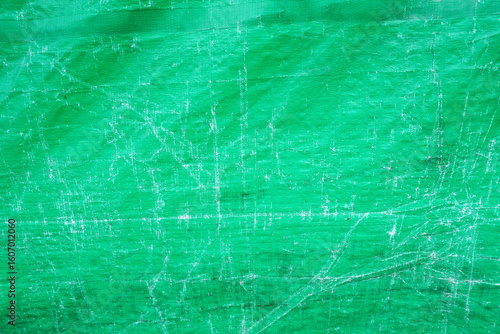 Vibrant green tarp with distressed texture for creative projects