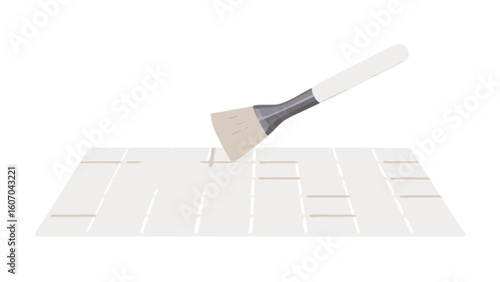 Applying grout to white ceramic tiles with brush for home renovation and diy projects and tile repair