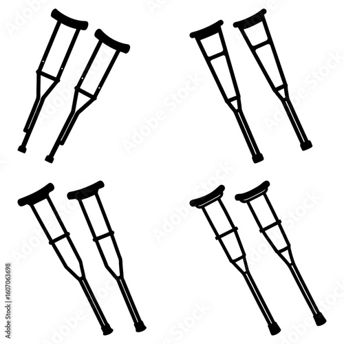 A collection of four pairs of black and white crutches arranged in a two by two grid pattern image view