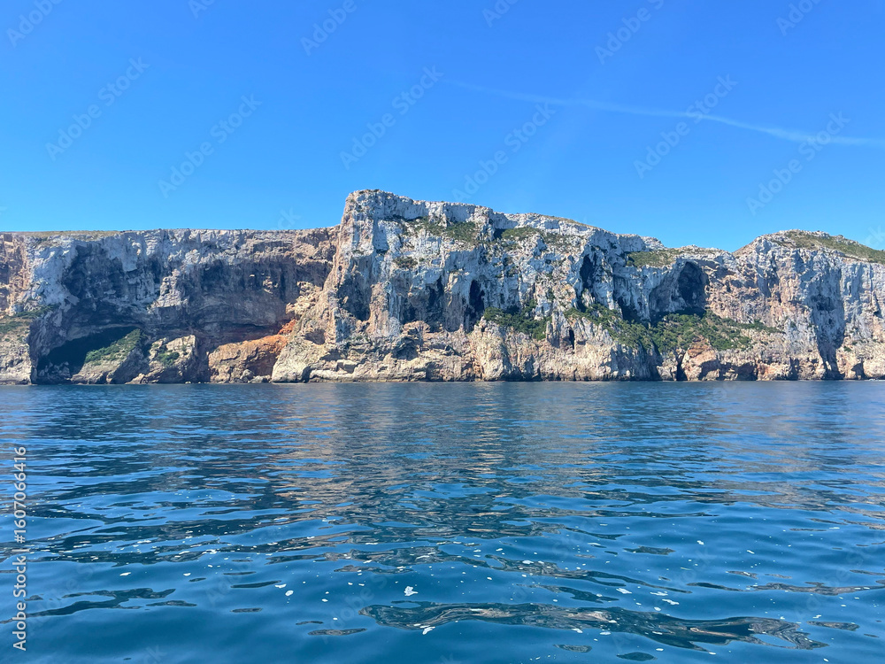 Fototapeta premium Rocky coastline with crystal clear blue sea