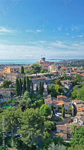 Wallpaper Mural Scenic aerial view of a picturesque coastal town with lush greenery, historic architecture, and serene blue waters, capturing the essence of Mediterranean charm and tranquility Torontodigital.ca
