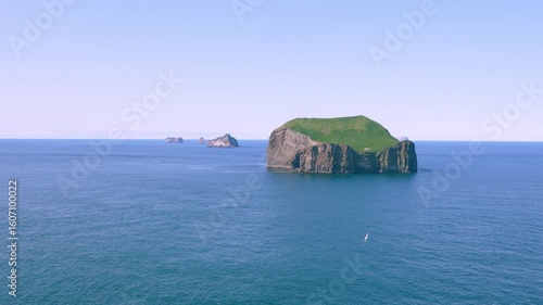 A breathtaking panoramic view of the rugged coastline and scattered islands of the Westman Islands, Iceland, showcasing dramatic geological formations and serene ocean vistas.