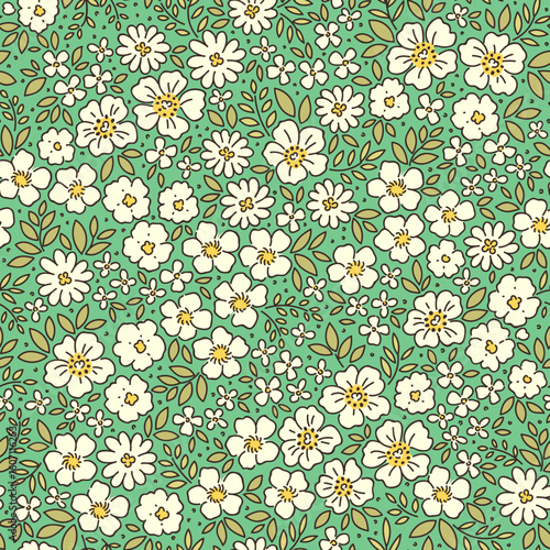 Vector seamless pattern. Vintage pattern in small flowers. Small cream white flowers. Brigh green background. Ditsy floral background. Delicate Spring template for fashion textile prints. Stock vector