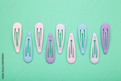 Photos Set of pastel hairpins on mint background.