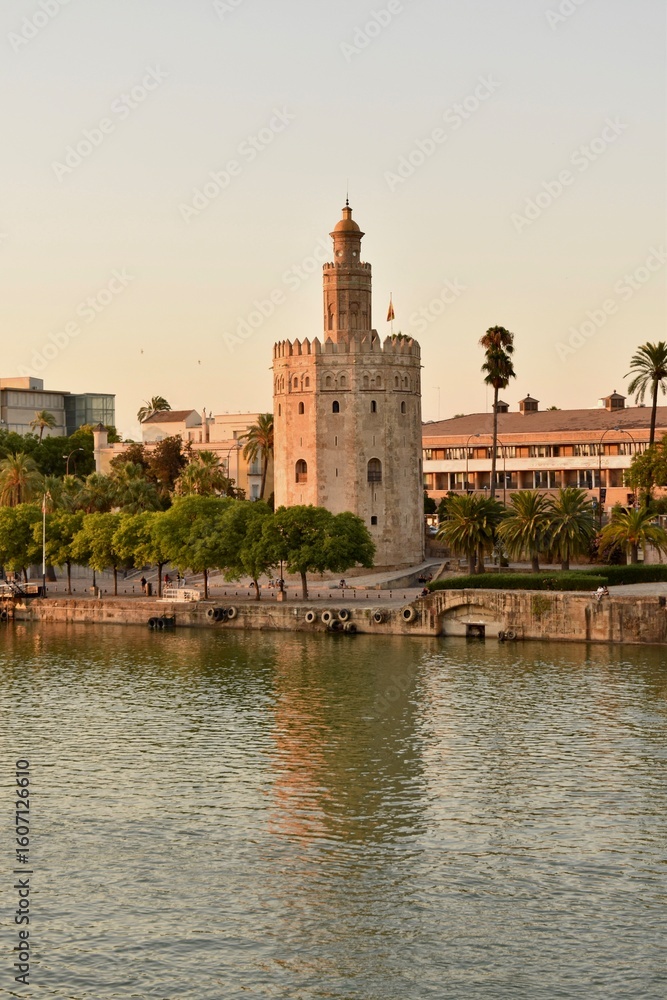 Obraz premium Torre del Oro, a historical tower in Seville, Spain, standing by the river. A symbol of the city’s rich past and tourism appeal.