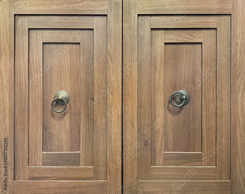 Close up of dark brown rustic wood drawers. Carpentry works, cabinet furniture concept. Dark grey and brown drawers door with knob. Vintage and antique furniture. Seamless background texture.