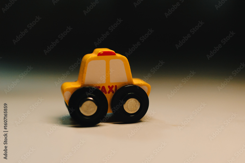 Obraz premium Playful toy taxi car indoor setting close-up view whimsical concept